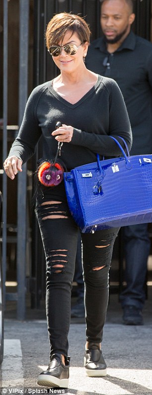 All about the accessories: Kris kept it casual in ripped jeans and a sweater but added a glam touch with a bold blue Hermes Birkin bag