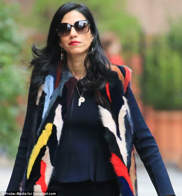 Shielding her eyes: Abedin wore oversize sunglasses for the early morning walk 