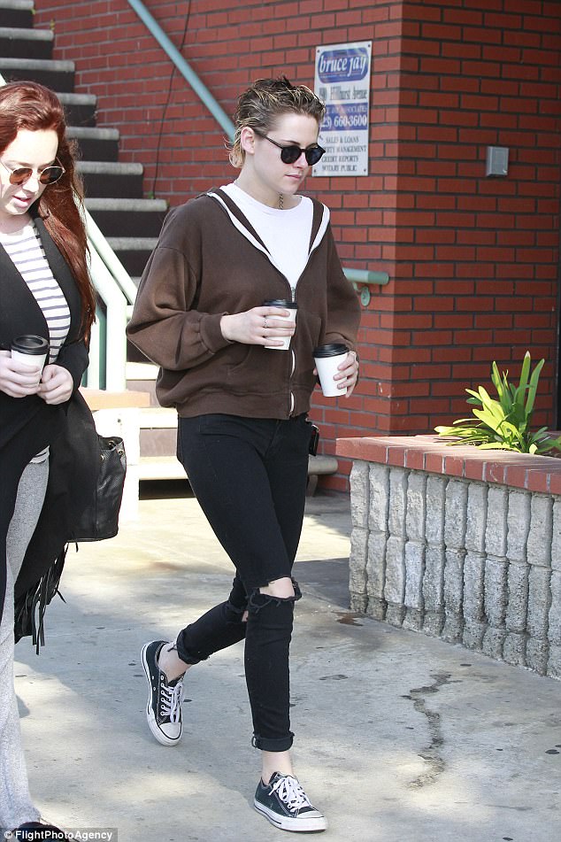 She has company: Ambling on a pair of black and white sneakers and wearing a simple white top, Kristen could be seen heading on her way beside a female friend
